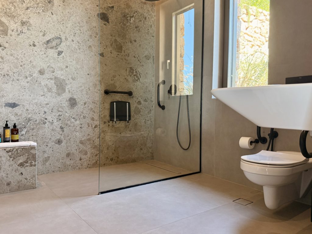 Santorini Sky Junior Residence Bathroom with Roll-in Shower | Accessible Villa | The Inclusive Edit