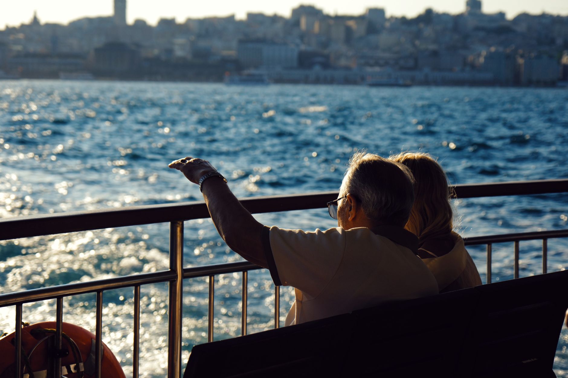senior couple enjoying waterfront view on ferry